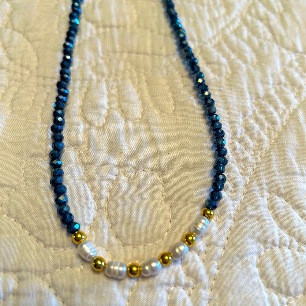 Blue stone necklace with gold beads and pearls.